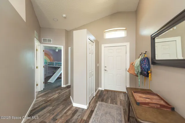 a view of hallway with wooden floor