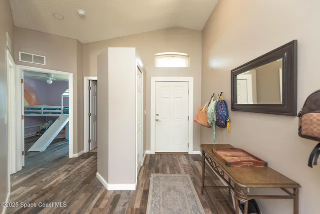 a view of room with furniture and wooden floor