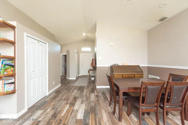 a dining room with a furniture and a window