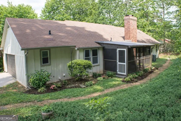 a front view of a house with a garden