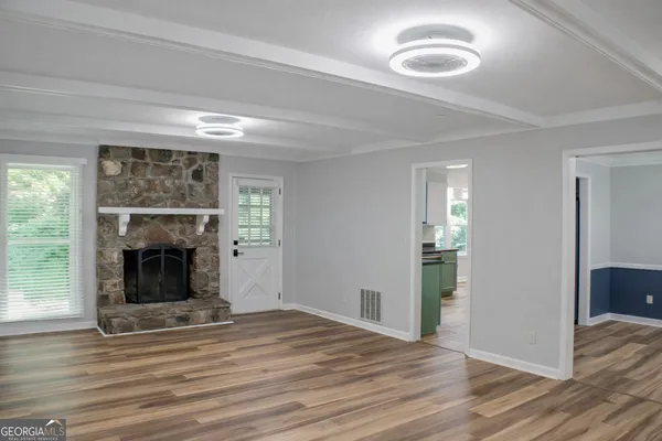 a view of a livingroom with a fireplace and window