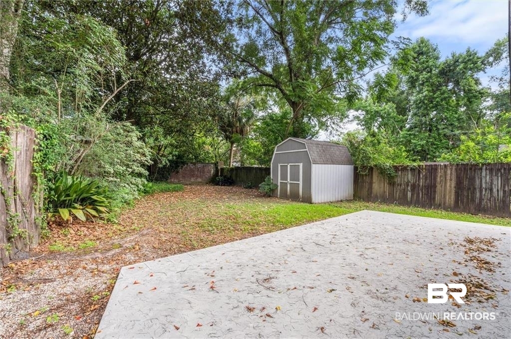 218 Grand Boulevard Mobile, AL 36607 - Photo 3 of 22 View of yard featuring a patio and a storage shed