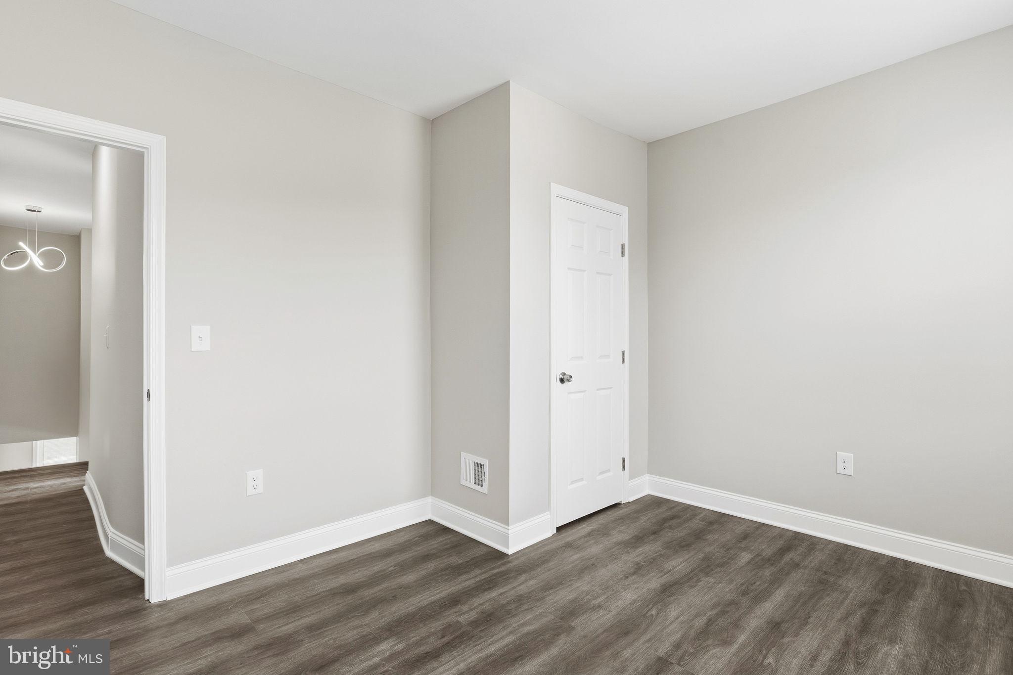 1200 North Dukeland Street Baltimore, MD 21216 - Photo 12 of 17 a view of an empty room with wooden floor and closet