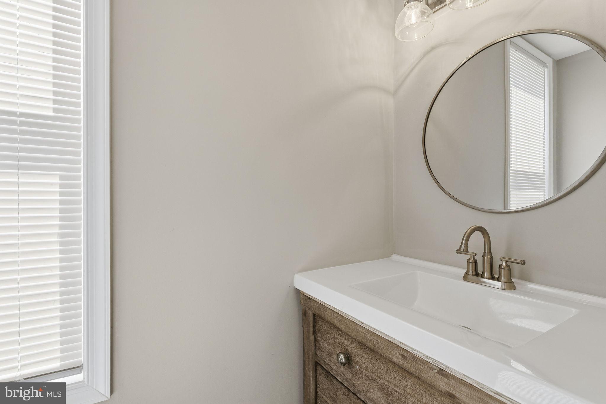 1200 North Dukeland Street Baltimore, MD 21216 - Photo 6 of 17 a bathroom with a sink and a mirror