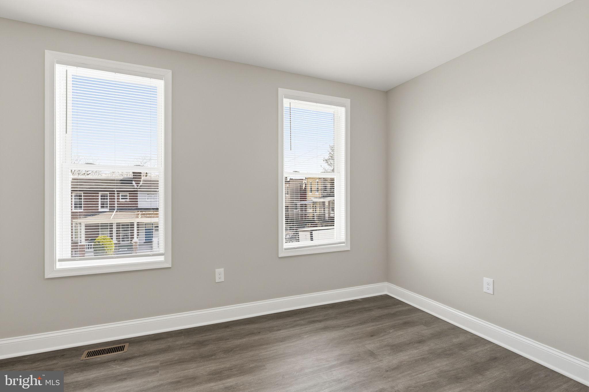 1200 North Dukeland Street Baltimore, MD 21216 - Photo 7 of 17 a view of an empty room with wooden floor and a window