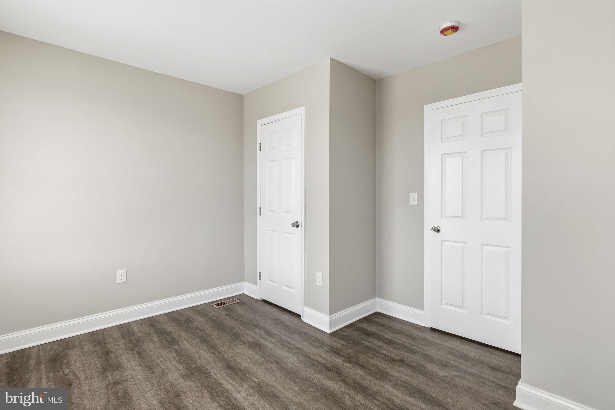 1200 North Dukeland Street Baltimore, MD 21216 - Photo 8 of 17 a view of an empty room with wooden floor and closet