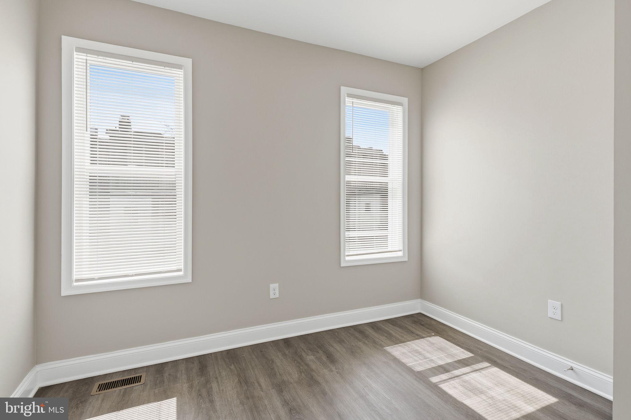 1200 North Dukeland Street Baltimore, MD 21216 - Photo 9 of 17 a view of an empty room with wooden floor and a window
