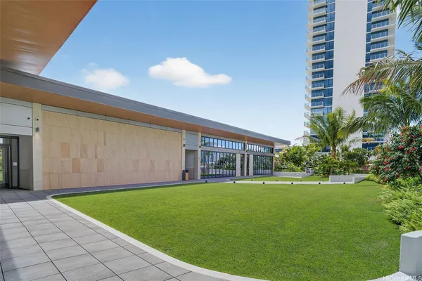 a view of a house with a big yard and potted plants