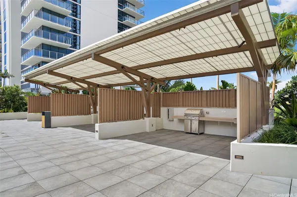 a view of patio with a table and chairs under an umbrella