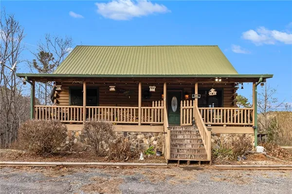 a view of a brick house with wooden fence