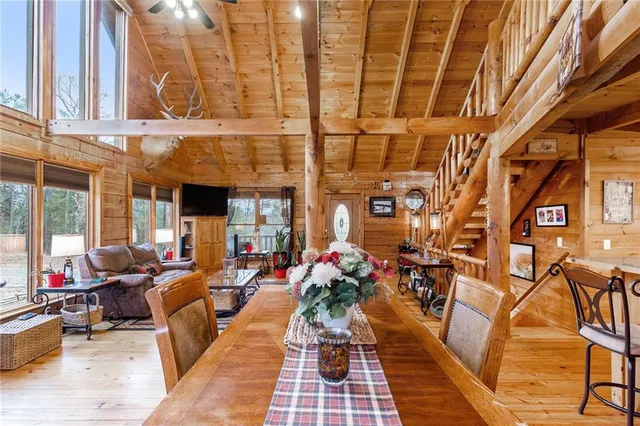 a kitchen with stainless steel appliances kitchen island granite countertop a table chairs in it and wooden floors