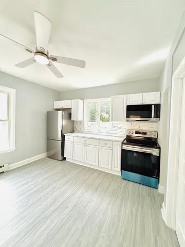 a kitchen with stainless steel appliances a stove top oven and sink