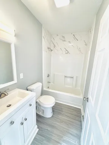 a bathroom with a double vanity sink toilet mirror and bathtub