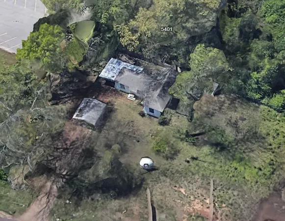 a aerial view of a house with a yard