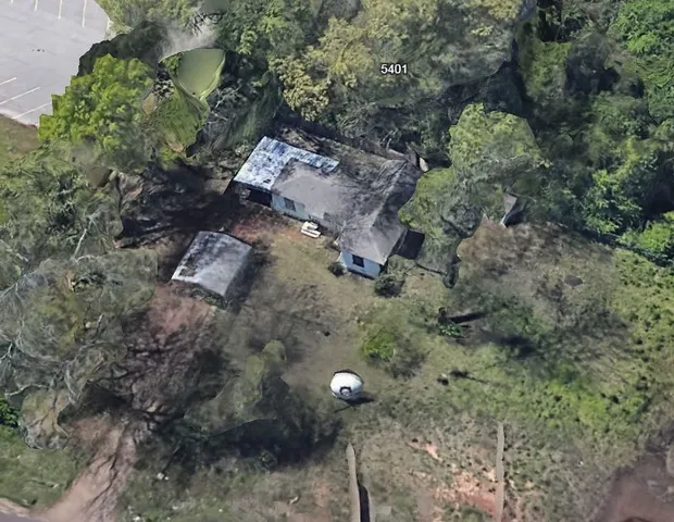 a aerial view of a house with a yard
