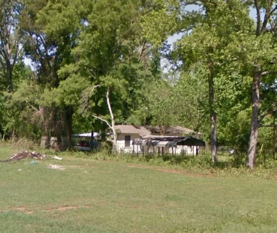a view of a house with a yard and sitting area