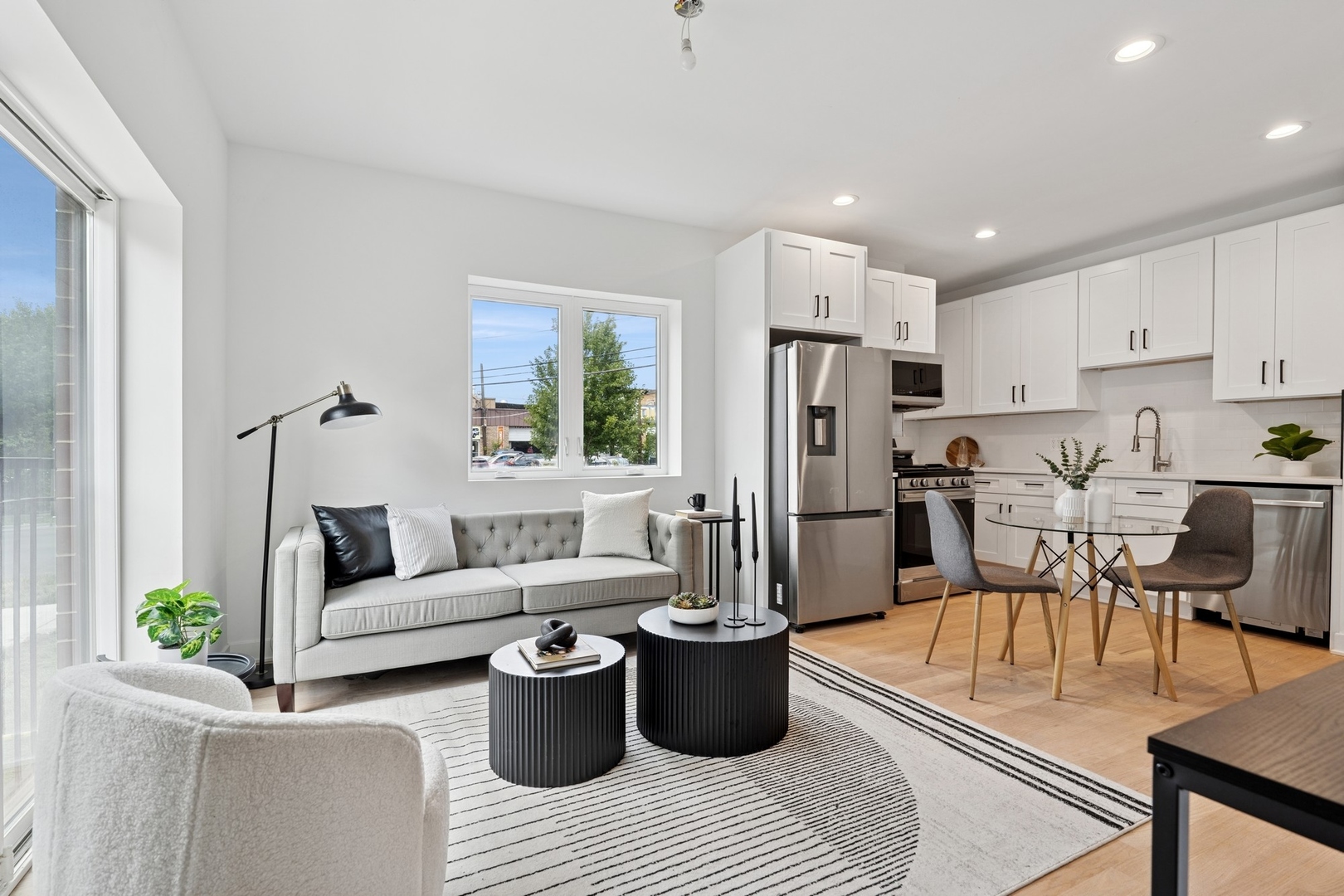 6755 North Hermitage Avenue, Unit 2 Chicago, IL 60626 - Photo 2 of 10 a living room with stainless steel appliances furniture a couch and a view of kitchen