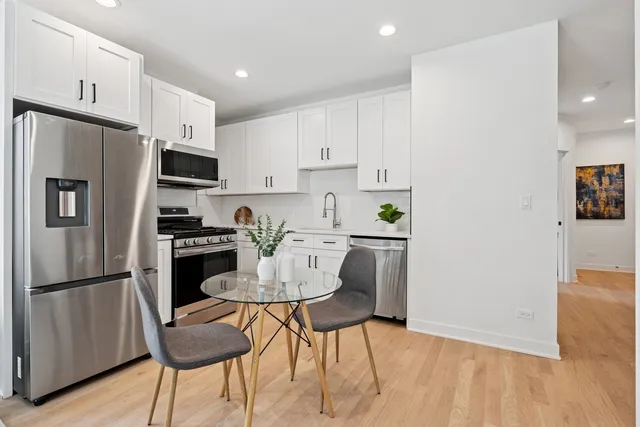 a kitchen with stainless steel appliances a refrigerator stove microwave and cabinets