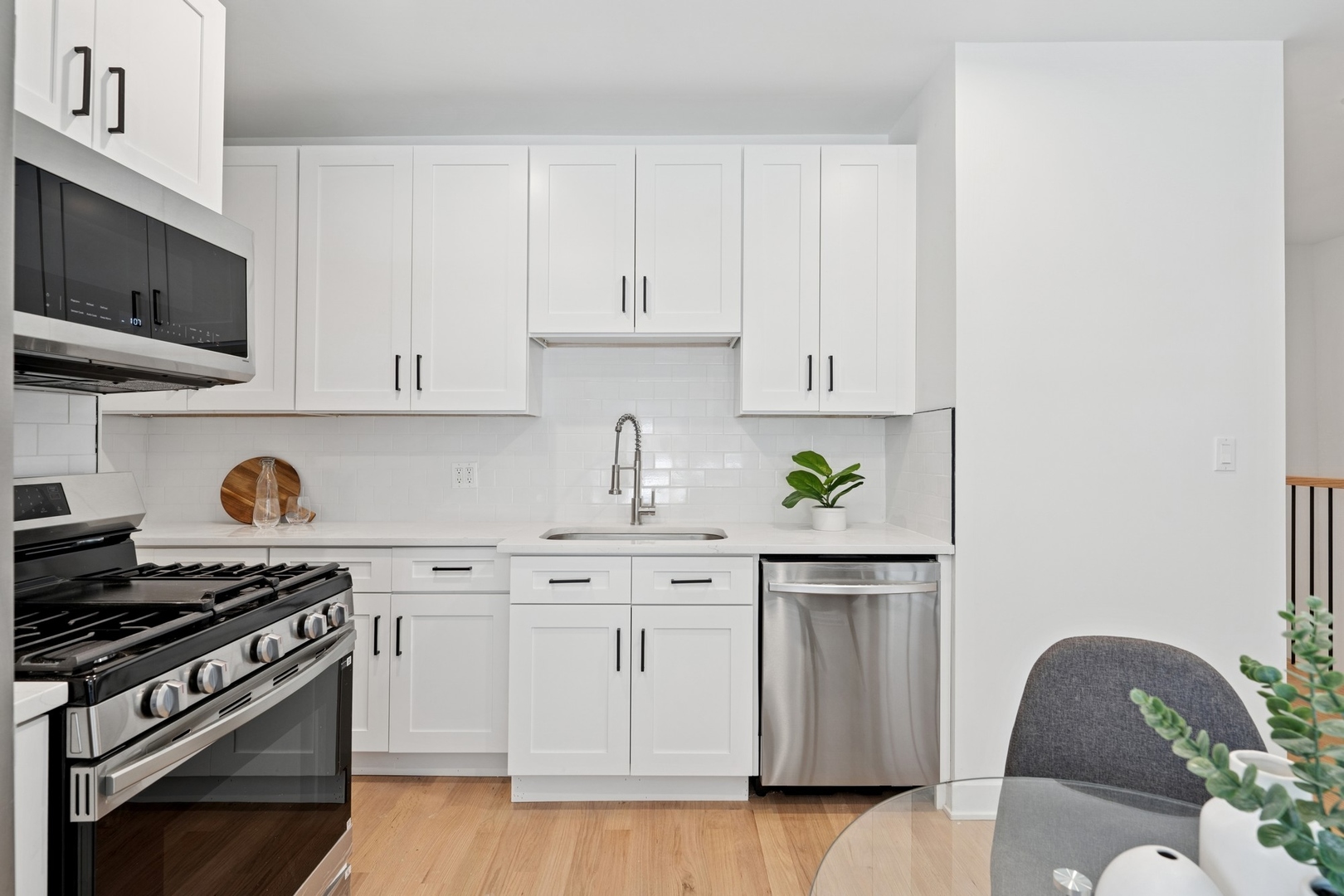 6755 North Hermitage Avenue, Unit 2 Chicago, IL 60626 - Photo 6 of 10 a kitchen with stainless steel appliances granite countertop a stove a white cabinets a sink and dishwasher