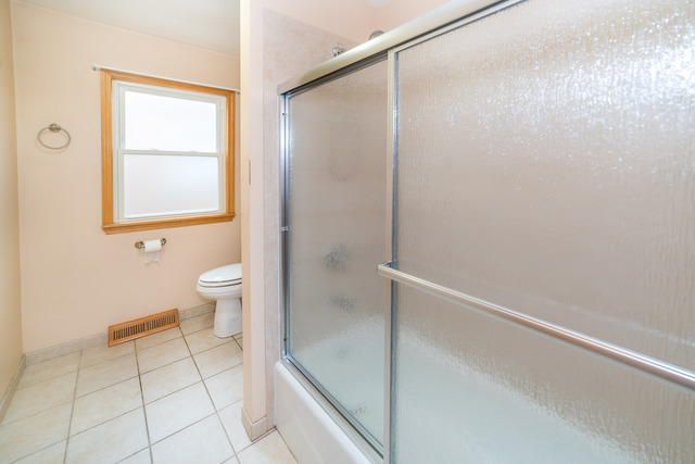 3648 West 81st Street Chicago, IL 60652 - Photo 11 of 17 a bathroom with a granite countertop sink a toilet and shower