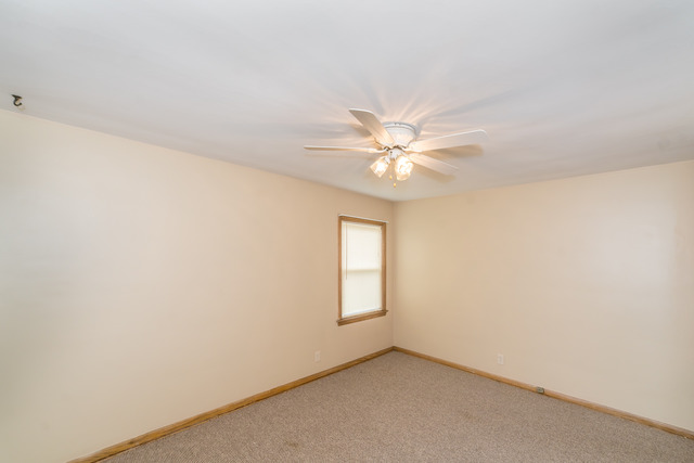 3648 West 81st Street Chicago, IL 60652 - Photo 9 of 17 an empty room with windows and fan