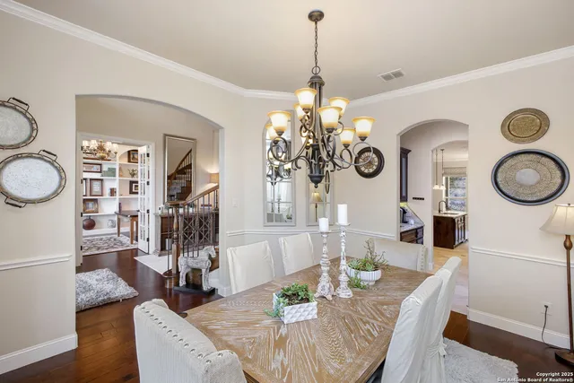 a view of a dining room with furniture a chandelier and wooden floor