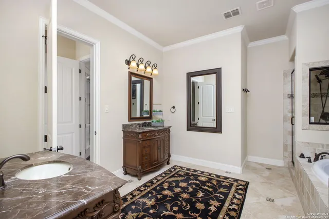 a spacious bathroom with a granite countertop sink and a mirror