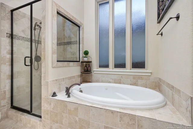 a bathroom with a bathtub and shower