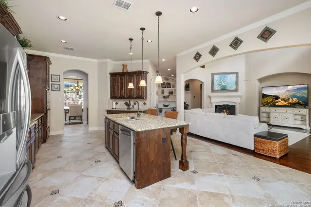 a large white kitchen with a large window
