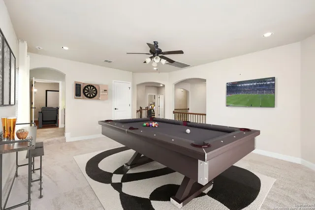 a black leather couch sitting in a living room next to a couch