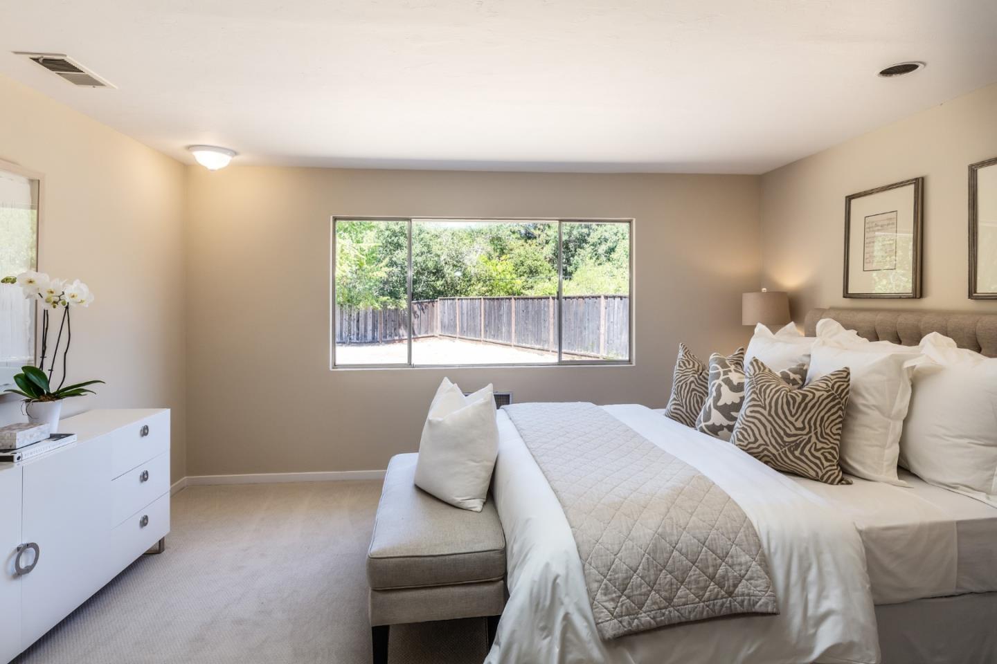 330 Corte Madera Road Portola Valley, CA 94028 - Photo 15 of 24 a bedroom with a bed and large windows