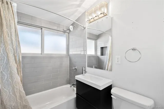 a view of empty room with window and with wooden floor