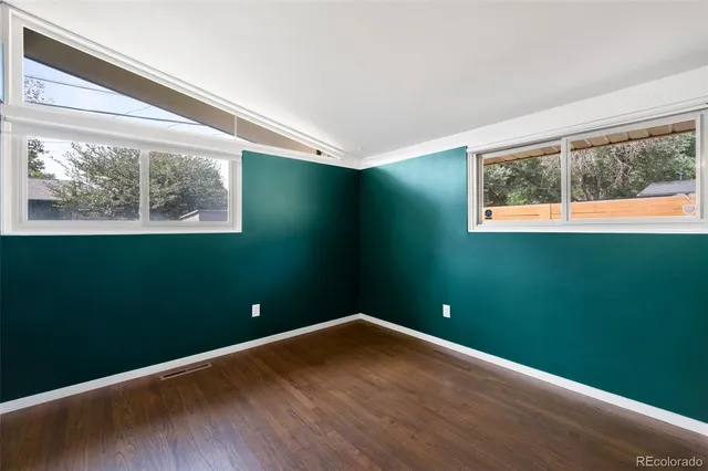 a view of a house with a door and wooden walls