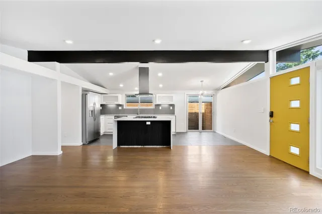 a large hall with an entryway and a wooden floor