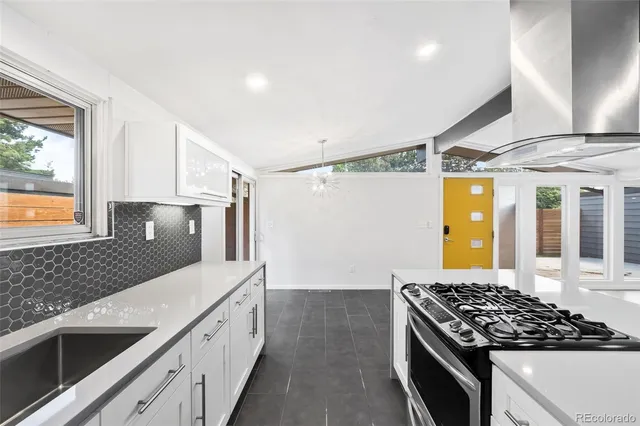 a kitchen with stainless steel appliances a stove and a refrigerator