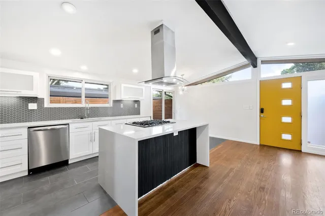a kitchen with a stove and a wooden floors