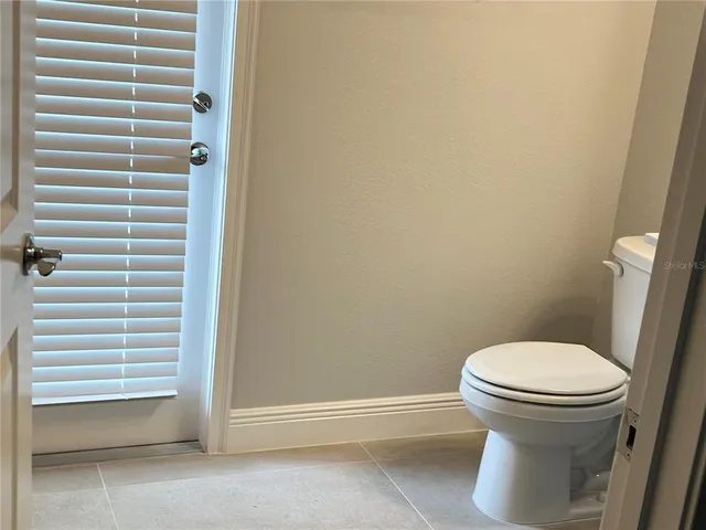 a white toilet sitting next to a shower