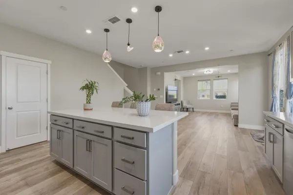 a view of a double vanity sink a mirror and wooden floor