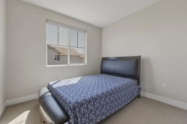 a bedroom with a bed and a dresser