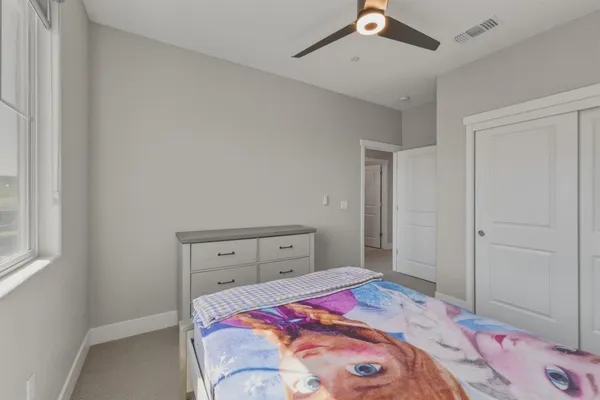 a bedroom with a bed and a cabinets