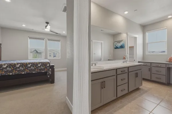 a bed sitting in a bedroom next to a window