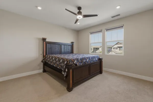 a bedroom with a large bed and a chandelier