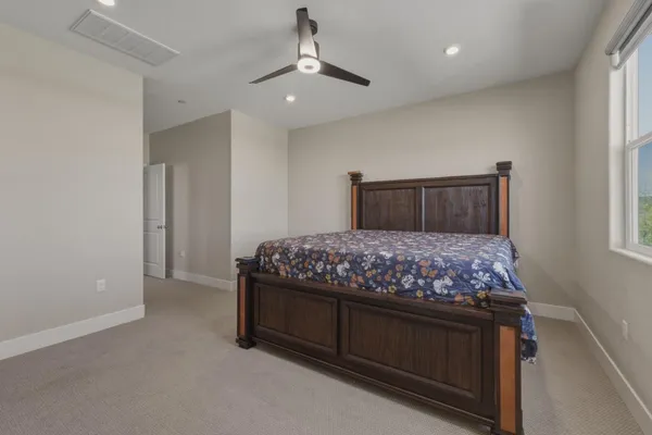 a bedroom with a bed and a chandelier