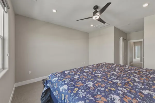 a spacious bathroom with a granite countertop sink mirror and cabinets