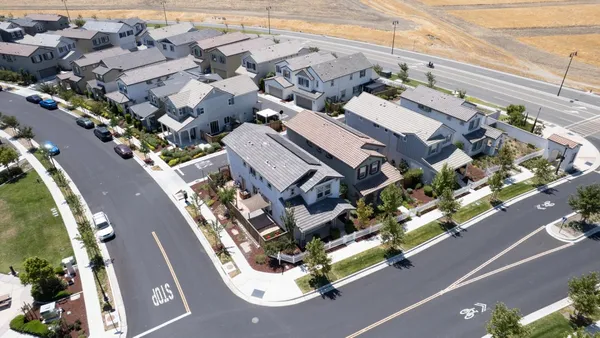 an aerial view of a residential houses with street
