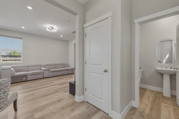 a living room with furniture and a wooden floor