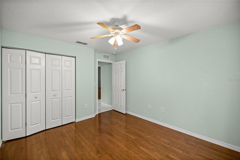 10891 Southwest 69th Circle Ocala, FL 34476 - Photo 19 of 28 a view of an empty room with wooden floor