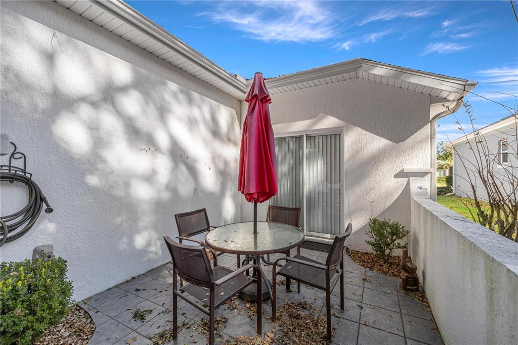 10891 Southwest 69th Circle Ocala, FL 34476 - Photo 26 of 28 a backyard of a house with table and chairs