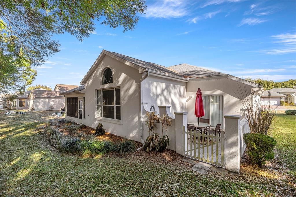 10891 Southwest 69th Circle Ocala, FL 34476 - Photo 27 of 28 a front view of a house with a yard