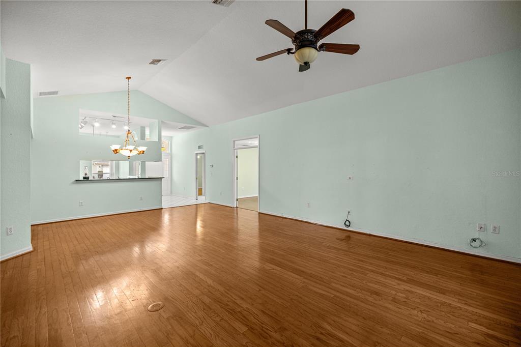 10891 Southwest 69th Circle Ocala, FL 34476 - Photo 6 of 28 an empty room with wooden floor and windows